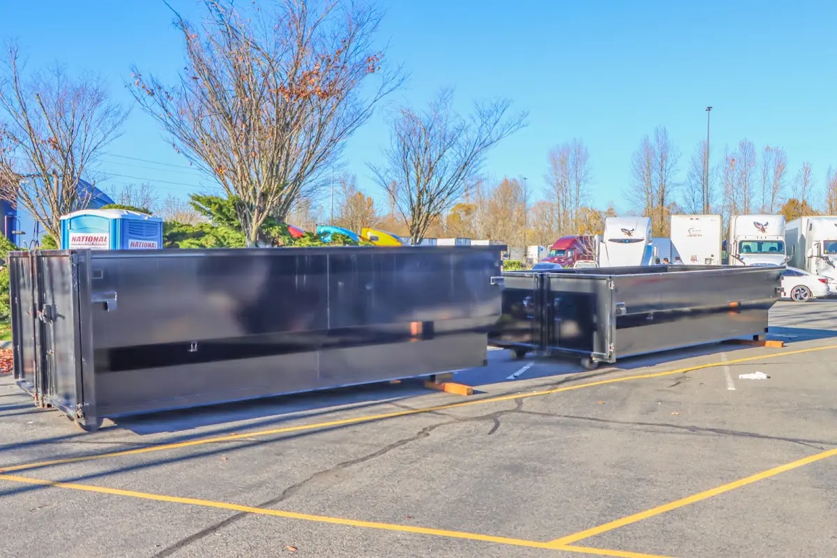 Professional dumpster rental service with roll-off container on residential driveway in Fort Madison